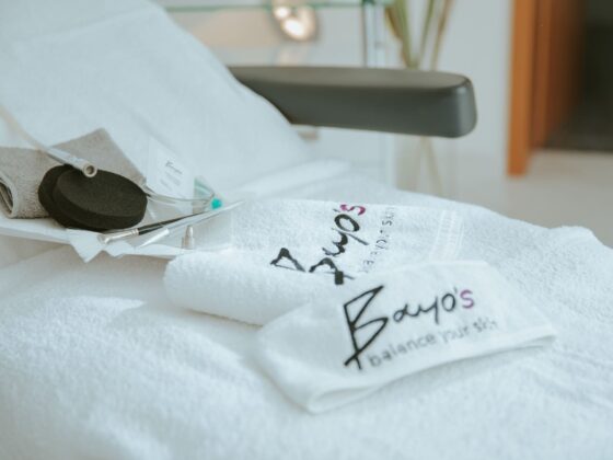 Ein weißes Handtuch liegt auf einem Bett in einem Spa mit ästhetischen Behandlungen.